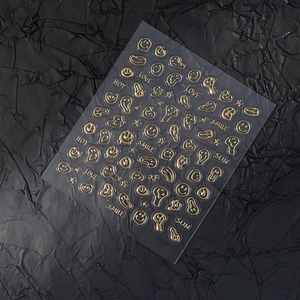 Golden embossed nail art stickers featuring melting smiley faces and star patterns