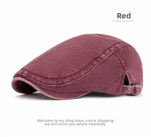 Detail of red washed cotton newsboy cap showing metal buckle and retro stitching