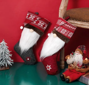 Detail of knitted Christmas stockings with gnome motifs and fluffy white beards