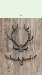 Close-up of vintage cast iron antler wall hooks with rustic texture on wooden background