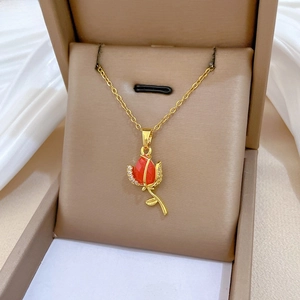 Close-up of titanium rose necklace with red gemstone and crystals in a gift box