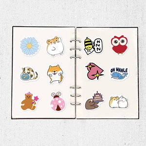 Cute cartoon animal stickers on a white notebook with hamster and whale designs