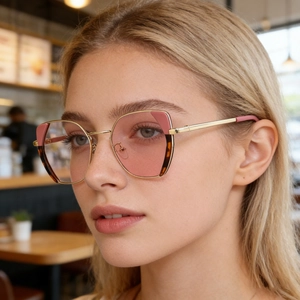 Detail of trendy pink cat-eye optical frames with gold metal and tortoise shell textures