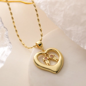 Gold necklace with hollow heart pendant featuring two girls on a bead chain