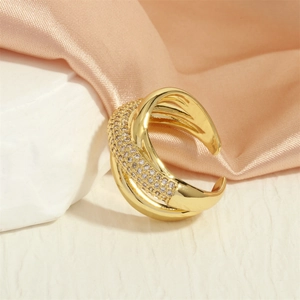 Detailed close-up of 18K gold-plated X-shape cross ring with micro-paved cubic zirconia