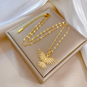 Golden phoenix wing necklace with micro-pave crystals on premium silk jewelry box