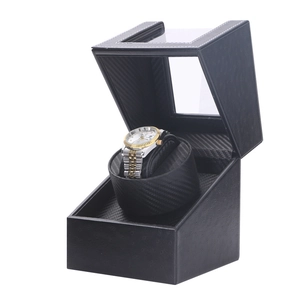 Detail of single automatic watch winder with black leather and carbon fiber texture