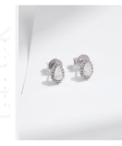 Close-up of S925 sterling silver pear-cut moissanite halo stud earrings with hallmarks