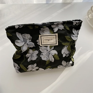 Detail of floral jacquard fabric bag with zipper closure and Pleasant Time label