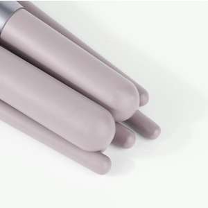 Detailed macro shot of purple matte handles and silver ferrules on makeup brushes