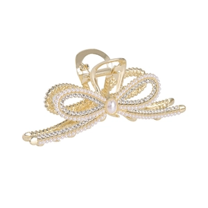 Elegant gold bow hair claw clip with sparkling rhinestones and pearls on white background