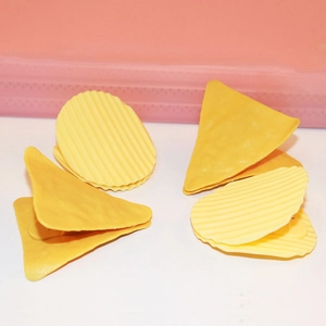 Macro detail of yellow wavy circular and triangular plastic paper clips for office decor