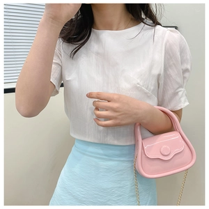 Pink jelly mini bag with gold chain strap shown on model for size and style reference