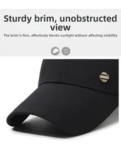 Detail view of the stiff brim and side metal badge on this black sun protection baseball cap