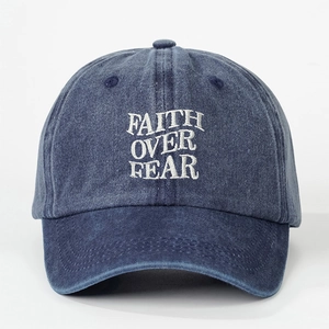 Vintage washed blue baseball cap featuring white Faith Over Fear embroidery detail