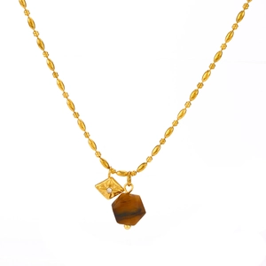Fashionable gold necklace featuring a tiger eye stone pillar and engraved square medal charm