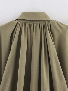Close-up of olive green baseball jacket collar showing pleated fabric texture and stitching