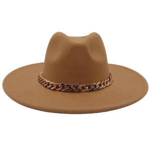Detail of tan wide brim fedora hat with elegant rose gold metal chain decoration
