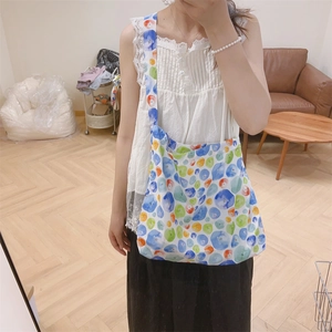 Detail of printed crossbody cotton bag with colorful watercolor polka dots and wide strap
