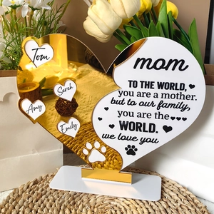 Macro detail of custom heart-shaped acrylic gift with golden mirror finish and message