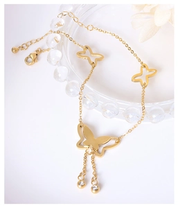Detailed close-up of 18k gold butterfly necklace with white rhinestones and lobster clasp