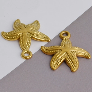 Detailed view of two gold starfish pendants with textured surface and top hanging rings