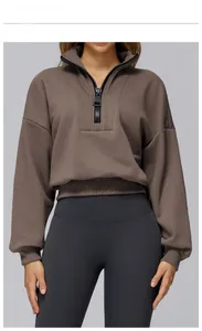 Close-up of cocoa brown half-zip sweatshirt with black zipper and loose athletic fit