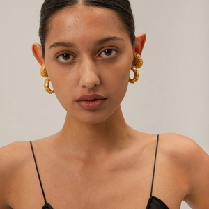 18k gold plated stainless steel C-shaped earrings with hammered texture on model