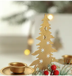 Detail of golden metal Christmas tree holder with hollow snowflake patterns and bokeh light