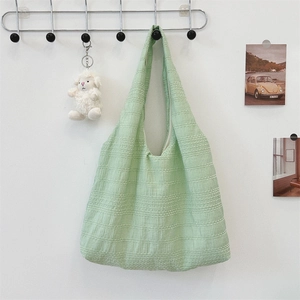Detailed view of mint green fabric tote bag showing textured cotton-linen weave pattern