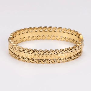 Vintage gold stainless steel bangle with hollow leaf geometric pattern for women