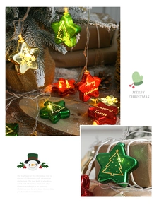 Close-up of star-shaped Christmas LED lights with Merry Christmas prints and tree motifs