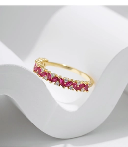 Macro shot of gold S925 silver ring with red marquise gemstone on a minimalist background