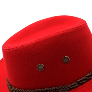 Detail of red suede fedora hat featuring brown twisted cord and metal ventilation eyelets