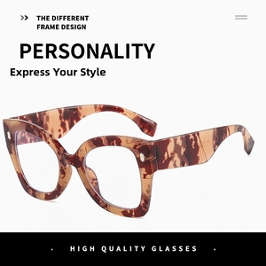 Close-up of leopard print oversized blue light glasses frames with wide temples and glossy finish