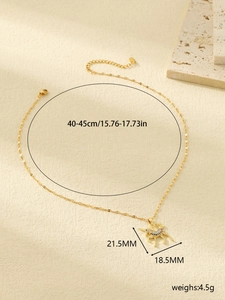 Detail view of a gold unicorn pendant with colorful zircons and size measurements
