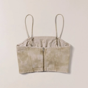 Detailed back view of distressed denim corset top with premium silver metal zipper