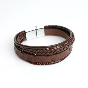 Macro shot of brown multi-layer braided leather bracelet with silver magnetic clasp