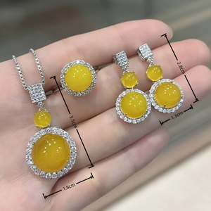 Detailed size view of yellow chalcedony necklace and earrings set with silver inlay