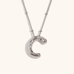 Detail of 3D balloon-style letter C pendant on a stainless steel bead chain necklace