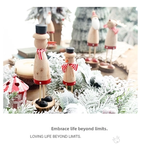 Close-up of wooden Christmas ornaments featuring elk and snowman with natural wood grain