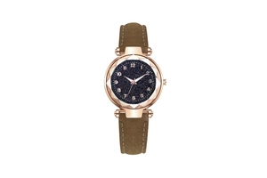 Detail of rose gold star-themed dial with faceted glass and brown suede leather strap