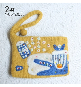 Detail of yellow handmade wool felt pouch with colorful beads and 14.5x20.5cm dimensions