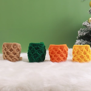 Set of four handmade crochet mug sleeves in beige, green, orange, and yellow yarn