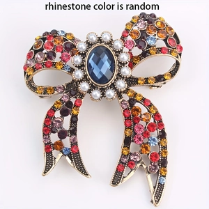 Vintage gold bow brooch with colorful rhinestones, pearls and large blue center stone
