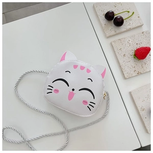 Close-up of white cat cartoon crossbody bag with soft woven strap and leather texture