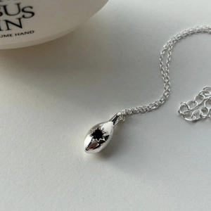 Elegant 925 sterling silver necklace with black star drop pendant on white background