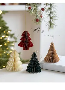 Detail of colorful paper honeycomb Christmas tree ornaments with elegant gold glitter edges