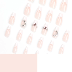 French tip press-on nails set with nude base, sparkling diamonds and moon decorations