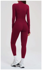 Rear view of deep red slim-fit long sleeve top and high-waisted leggings with side pockets